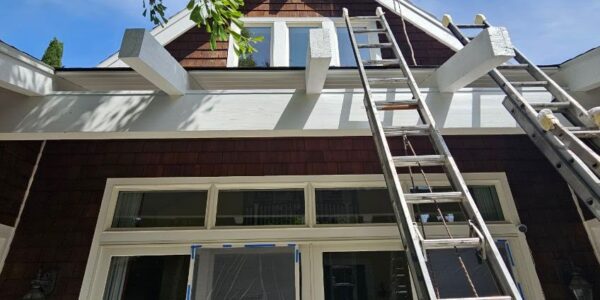 28f52db4269b2f391be232c75f4a055fa16864fa-2 Home maintenance professional performing exterior paint touch-ups to improve curb appeal.